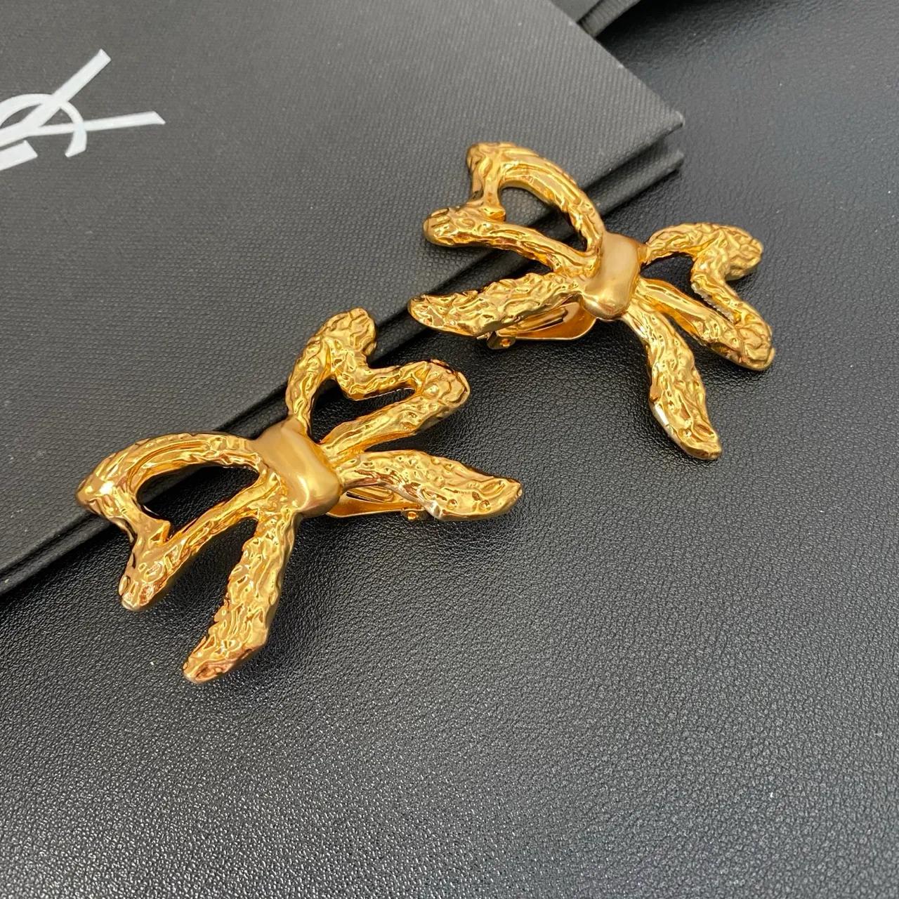 Saint Laurent Gold Sculpted Bow Textured Metal Earrings