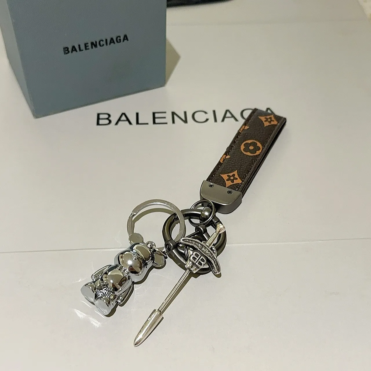 Balenciaga Bear Keychain Brown Silver Monogrammed Leather Strap Polished Metal Charm Phone Case