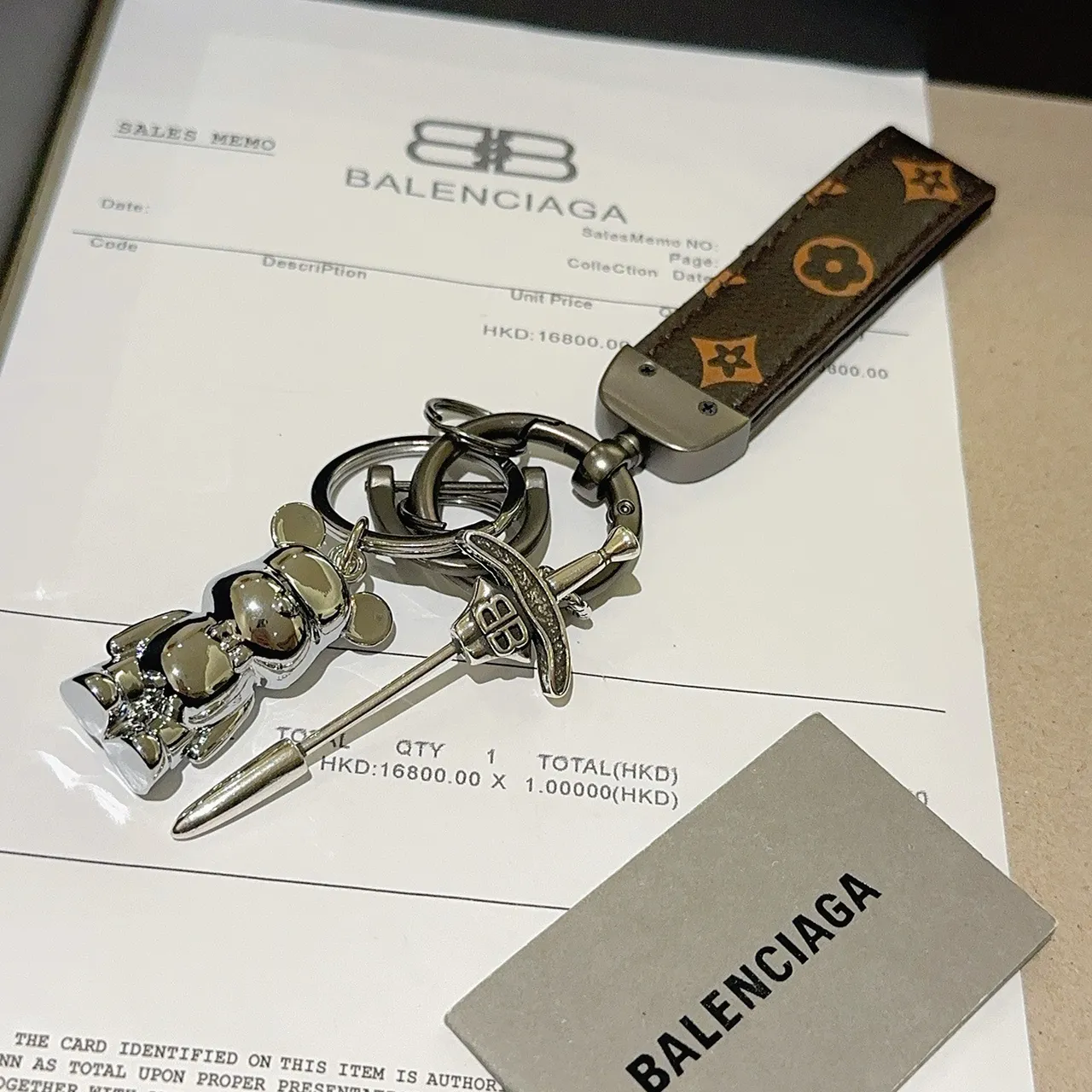 Balenciaga Bear Keychain Brown Silver Monogrammed Leather Strap Polished Metal Charm Phone Case