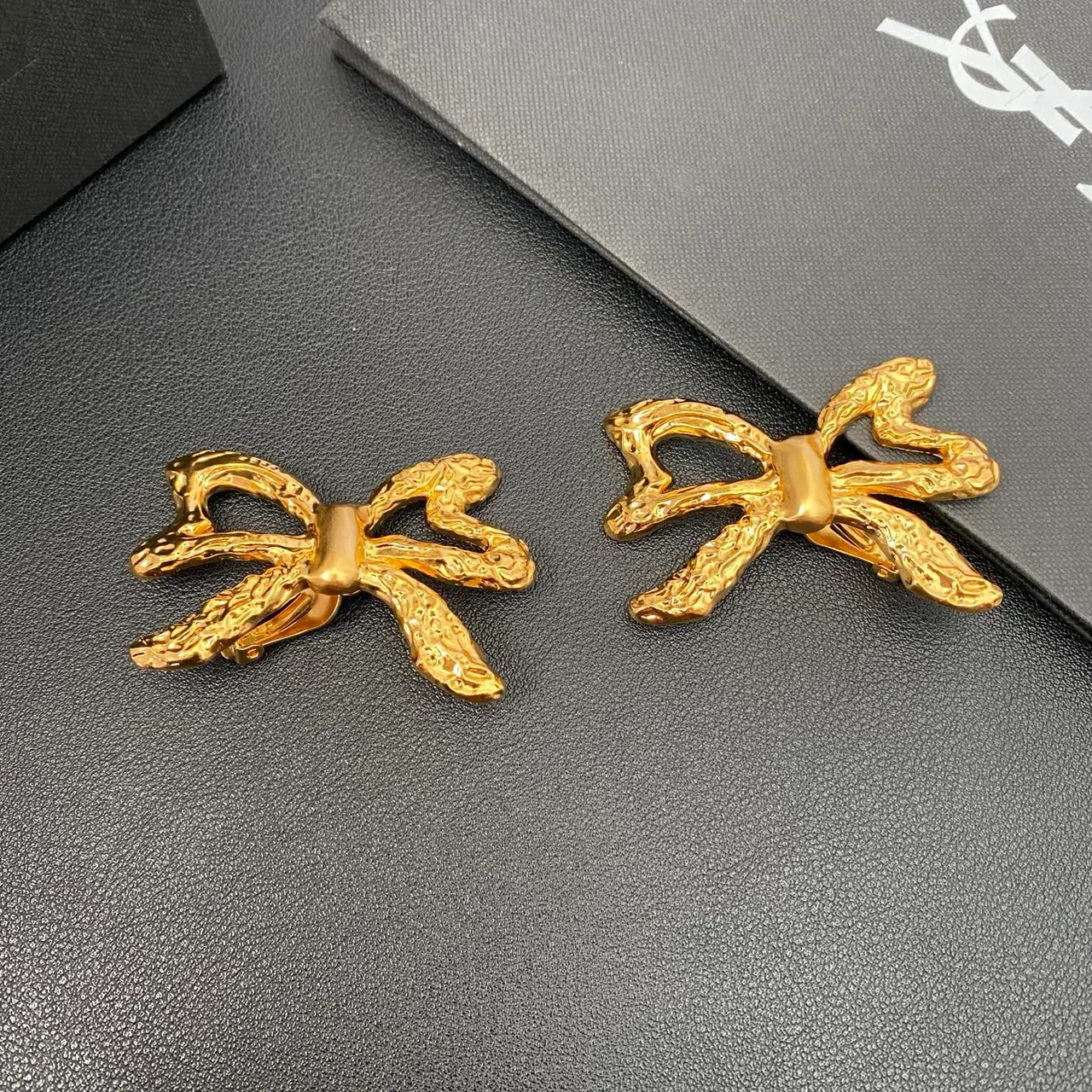 Saint Laurent Gold Sculpted Bow Textured Metal Earrings