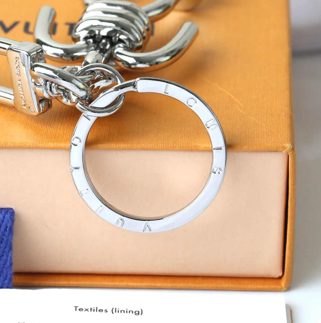 Louis Vuitton Silver Blue Polished Metal Figurine-Shaped Phone Accessory