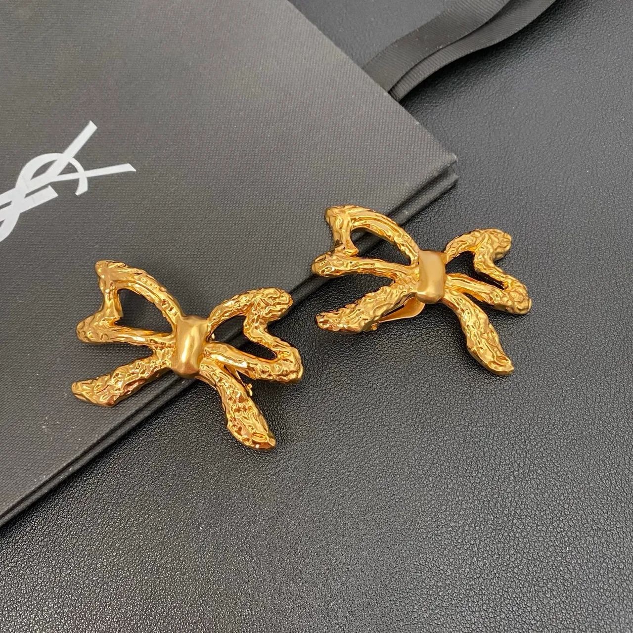 Saint Laurent Gold Sculpted Bow Textured Metal Earrings