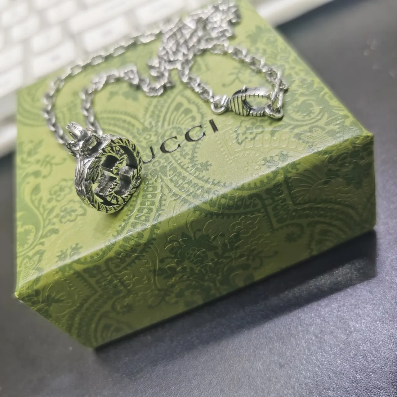 Gucci Silver Interlocking Double-G Pendant Engraved Laurel Wreath Border Necklace