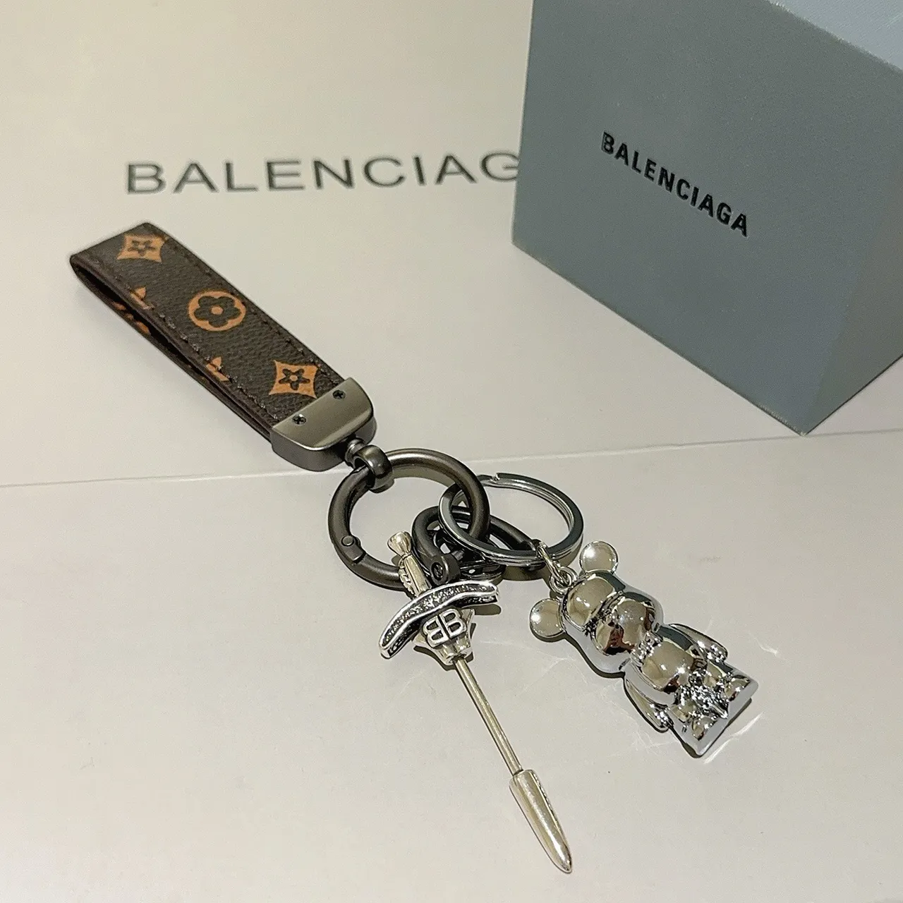 Balenciaga Bear Keychain Brown Silver Monogrammed Leather Strap Polished Metal Charm Phone Case
