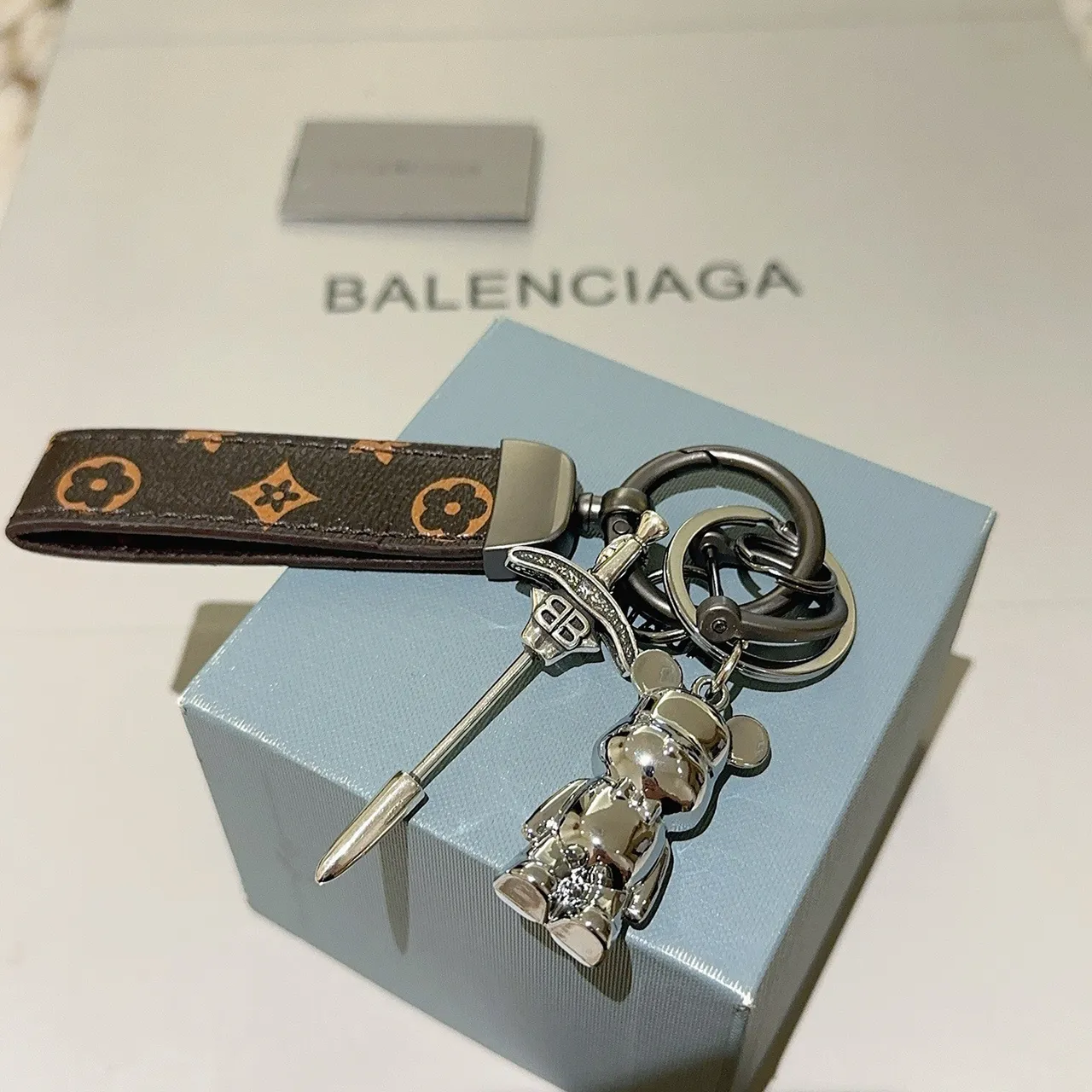 Balenciaga Bear Keychain Brown Silver Monogrammed Leather Strap Polished Metal Charm Phone Case