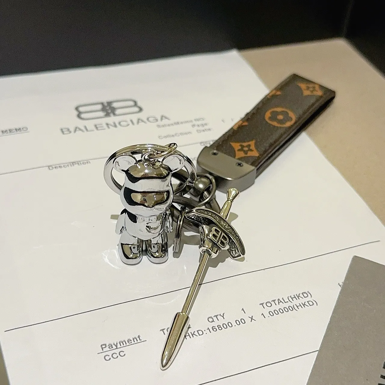 Balenciaga Bear Keychain Brown Silver Monogrammed Leather Strap Polished Metal Charm Phone Case