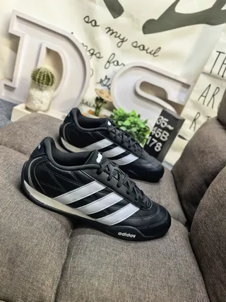 Adidas Black and White Three-Stripe Leather Low-Top Lifestyle Sneakers