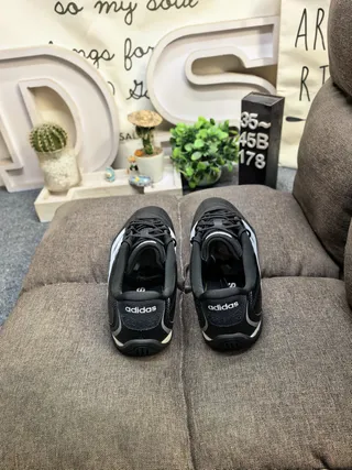 Adidas Black and White Three-Stripe Leather Low-Top Lifestyle Sneakers