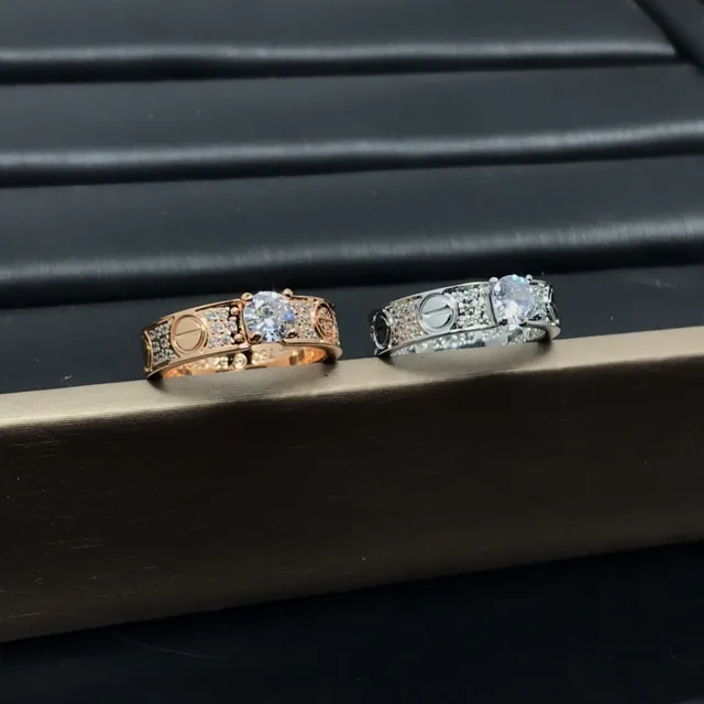Cartier Love Ring Silver and Gold Pavé Diamond Central Stone Rings