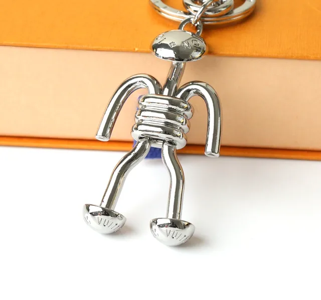 Louis Vuitton Silver Blue Polished Metal Figurine-Shaped Phone Accessory