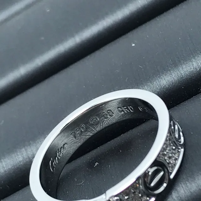 Cartier Love Ring Silver and Gold Pavé Diamond Central Stone Rings