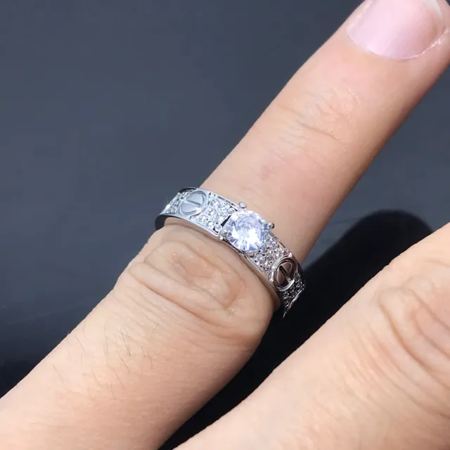 Cartier Love Ring Silver and Gold Pavé Diamond Central Stone Rings