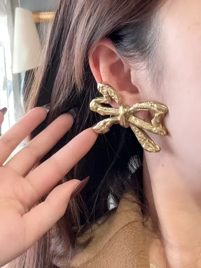 Saint Laurent Gold Sculpted Bow Textured Metal Earrings
