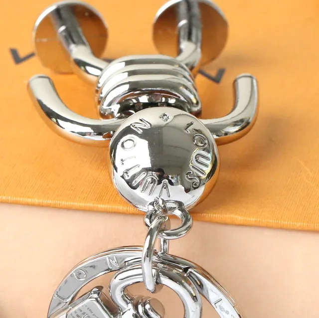 Louis Vuitton Silver Blue Polished Metal Figurine-Shaped Phone Accessory